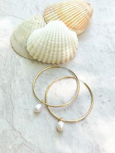 These elegant earrings are thin light endless hoops with a simple pearl drop. Great for going from day to night! Gold plated. Hoop is 1.5" across, with pearl drop total length is 2". Simple Pearl, Day To Night, To Night, Elegant Earrings, Pearl Drop, Gold Plate, Bangles, Hoop Earrings, Plating