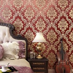 a bed room with a neatly made bed and wall paper