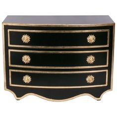 a black and gold dresser with three drawers