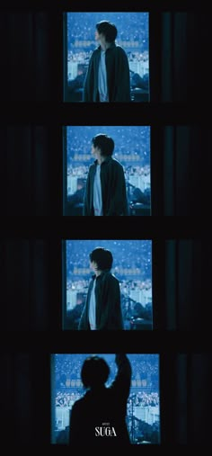 a man standing next to a window in the dark