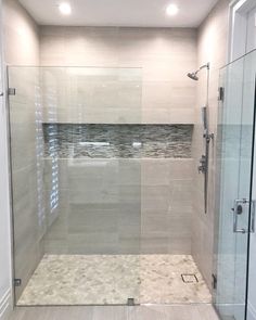 a walk in shower sitting next to a glass door