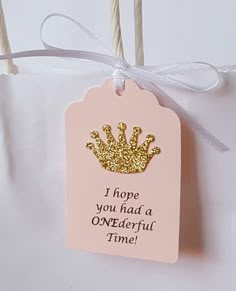 a pink and gold tag with a crown on it that says i hope you had a onederful time