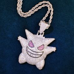 This beautiful gold-plated necklace is a must-have for any fan of the popular anime series. It features a stunning pendant in the shape of Gangar, a ghost/poison type Pokemon.The Gangar Pokemon Necklace is made from high quality materials and is plated with real gold, making it both stylish and durable. It's also affordably priced, so you can get your hands on this must-have necklace without breaking the bank.Whether you're looking for a gift for a fellow Pokemon fan or treating yourself to a li Poison Type Pokemon, Pokemon Necklace, Anime Necklace, Hello Kitty Shoes, Rapper Jewelry, Hip Hop Chains, Type Pokemon, Tennis Chain, Unisex Necklace