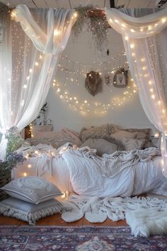 a bedroom with lights strung from the ceiling and curtains over the bed, along with rugs on the floor