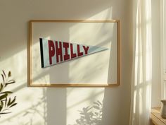 a framed photograph hanging on the wall next to a potted plant