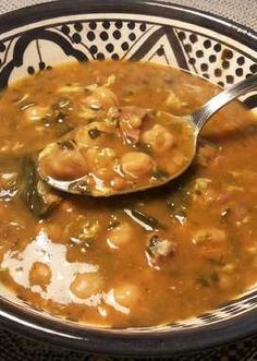 a bowl filled with soup and a spoon in it