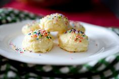 small cookies with sprinkles on a white plate