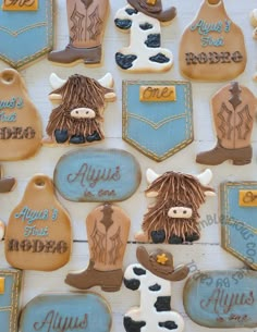 decorated cookies are arranged on a table with cowboy boots and other items in the shape of cowgirls