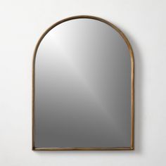 an arched mirror hanging on the wall