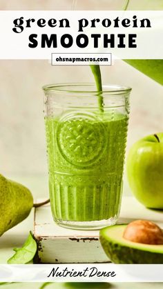 green protein smoothie in a glass with an apple and avocado on the side