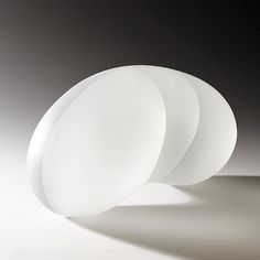 three white plates sitting next to each other on top of a table in front of a black background