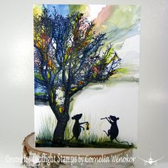 a card with two cats playing instruments under a tree