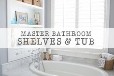 a white bath tub sitting under a window next to a shelf filled with towels and other items