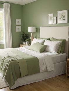 a bedroom with green walls and white bedding