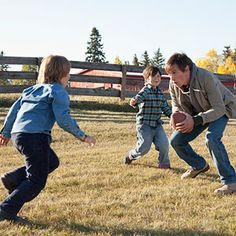 a man and two children playing with a frisbee