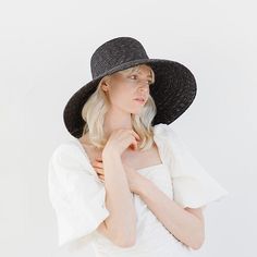 Jolie is a showstopper with an ultra-classic silhouette. Braided from all-natural wheat straw, its unique weave gives this bell-shaped hat depth + texture that continues through the sloped brim. Jolie's bold + beautiful style inspires major confidence. Limited Edition Jolie has been moved to its own page! To shop, click HERE! Limited Edition Jolie is a relaxed, modern take on the bestselling Jolie. This elevated Raffia material creates movement while keeping the wide brim + tall crown this style Adjustable Black Straw Hat Made Of Paper Straw, Modern Beach Hats For Summer, Modern Brimmed Panama Hat For Summer, Modern Curved Brim Hats For Spring, Elegant Woven Brimmed Straw Hat, Modern Summer Beach Hats, Modern Spring Hats With Curved Brim, Modern Spring Hat With Curved Brim, Modern Beach Hats For Spring