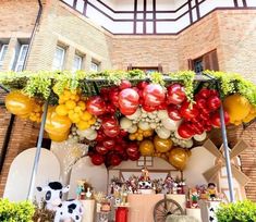 an outdoor bar with balloons and decorations on the outside, along with cow figurines