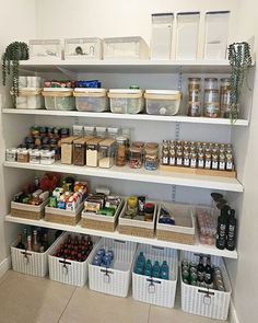 an organized pantry filled with lots of food and containers on the bottom shelf, along with plastic bins