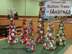 christmas trees made from buttons are on display