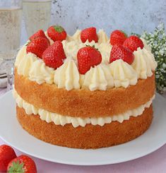 a cake with white frosting and strawberries on top