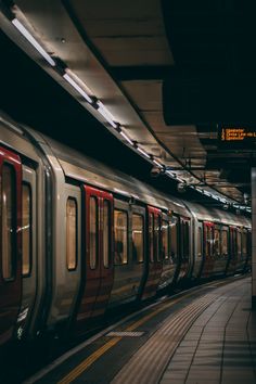 a subway train pulling into the station at night