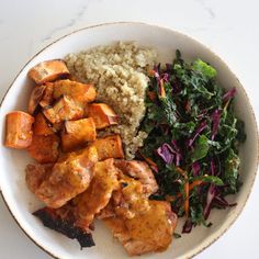 a white plate topped with meat, rice and veggies