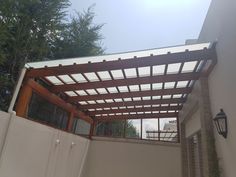 an outdoor patio with a pergolated roof and wooden slats on the sides