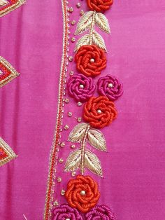 an embroidered pink and red dress with flowers on it