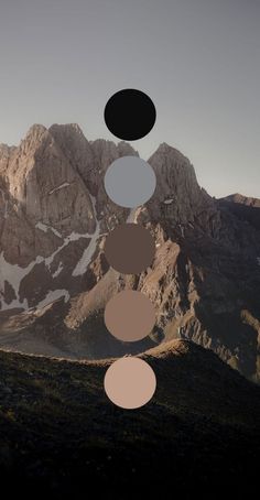 an image of mountains with circles in the sky