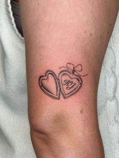 a couple of hearts tattoo on the arm