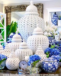 blue and white vases are arranged on a table