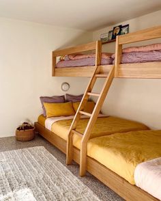 two bunk beds in a bedroom with yellow sheets and pillows on the bottom bunk bed