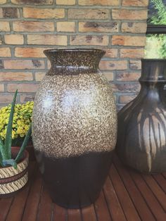 three vases sitting on top of a wooden table