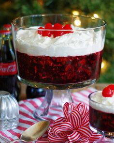 a red velvet trifle with white frosting and candy canes on the table