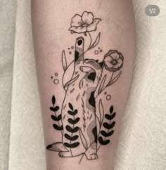 a black and white tattoo of a fox with flowers