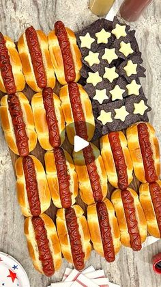 several hot dogs on buns with american flag decorations in the shape of an american flag