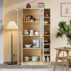 an open bookcase in the corner of a room with a table and chairs next to it