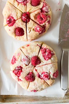 two raspberry shortbreads cut into slices on top of a baking sheet