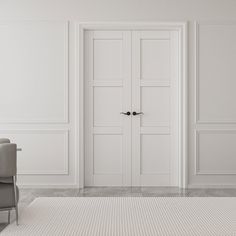 an empty room with two doors and a chair in the foreground, there is a rug on the floor