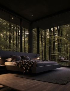 a large bed sitting in the middle of a bedroom next to a window filled with trees