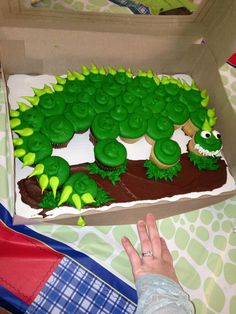 a cake in the shape of a green dragon