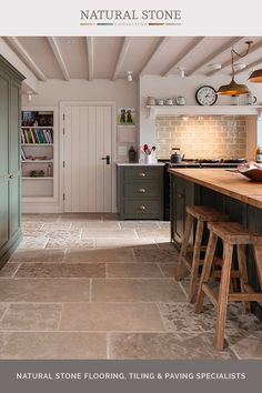 an image of a kitchen setting with natural stone flooring