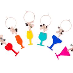 six wine glasses with charms hanging from each one's earring, all in different colors