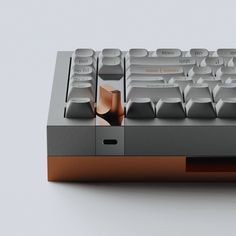 a computer keyboard sitting on top of a white table next to a black and brown mouse