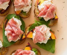 several pieces of bread topped with meat and veggies on top of each other