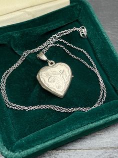 Vintage  silver locket for women. Double sided silver locket with hand engraved back and front.  Silver heart locket. Silver pendant . Silver necklace for women.       Vintage circa 70s. Condition: necklace in perfect vintage condition. Materials: Silver. Rhodium plated silver chain.  Measure: chain 16"/ 41 cm,   Locket  0.7" x 0.7"/  1.8 x 1.8 cm. Package: gift wrap available, please specify when ordering. Delivery: your order will be send by Royal Mail with tracking and signed in 1-2 working d Vintage Necklace With Engraving Option For Keepsake, White Gold Heart Pendant Locket Necklace For Gift, Victorian Hallmark Jewelry For Memorial, Antique White Gold Necklaces With Locket, Vintage White Gold Jewelry With Engraving Option, Antique White Gold Necklace With Locket, Victorian Memorial Jewelry With Hallmark, Silver Locket For Valentine's Day, Silver Round Locket Necklace For Valentine's Day