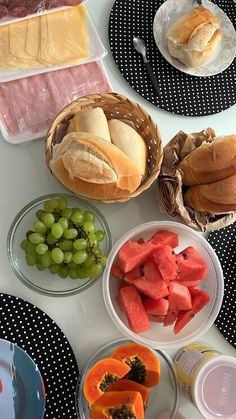 a table topped with plates and bowls filled with different types of food next to each other