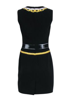 Looking to add a little fun to your wardrobe? This unique statement piece from Moschino was made for you! A playful golden chain graphic adorns this black sleeveless mini dress. Style this wardrobe staple with a simple black pointed toe pump and gold jewelry. Size 42 (8) 64% Triacetate, 36% Polyester Back zipper Scoop neck Sleeveless Bust 34" Waist 30" Shoulder to hem 35.5" Chic Sleeveless Mini Dress With Chain Strap, Sleeveless Mini Dress With Chain Strap For Evening, Chic Fitted Dress With Chain Print, Black Formal Dress With Chain Strap, Chic Chain Print Party Dresses, Chic Chain Print Dresses For Party, Sleeveless Mini Dress With Chain Strap For Cocktail, Elegant Black Dress With Chain Print, Chic Party Dress With Chain Print