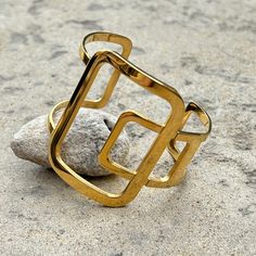 This bold and easy to wear statement cuff bracelet is the perfect addition to your jewelry wardrobe. Made from 18K gold plated stainless steel, this piece is waterproof and tarnish free. 18K PVD gold plated stainless steel - for an affordable high-end look Inner diameter: ~2.25" - allows for sliding up the arm Open design - Show some skin, or wear over a sleeve Imported from China - to bring you the best possible price This product has been curated by Tammy to complement our handmade collections Statement Cuff Bracelet, Jewelry Wardrobe, Open Design, Statement Bracelet, Design Show, Earring Necklace, Ring Necklace, Cuff Bracelet, Jewelry Shop