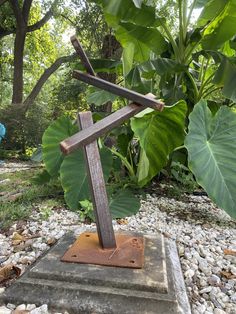 a wooden cross sitting on top of a stone slab